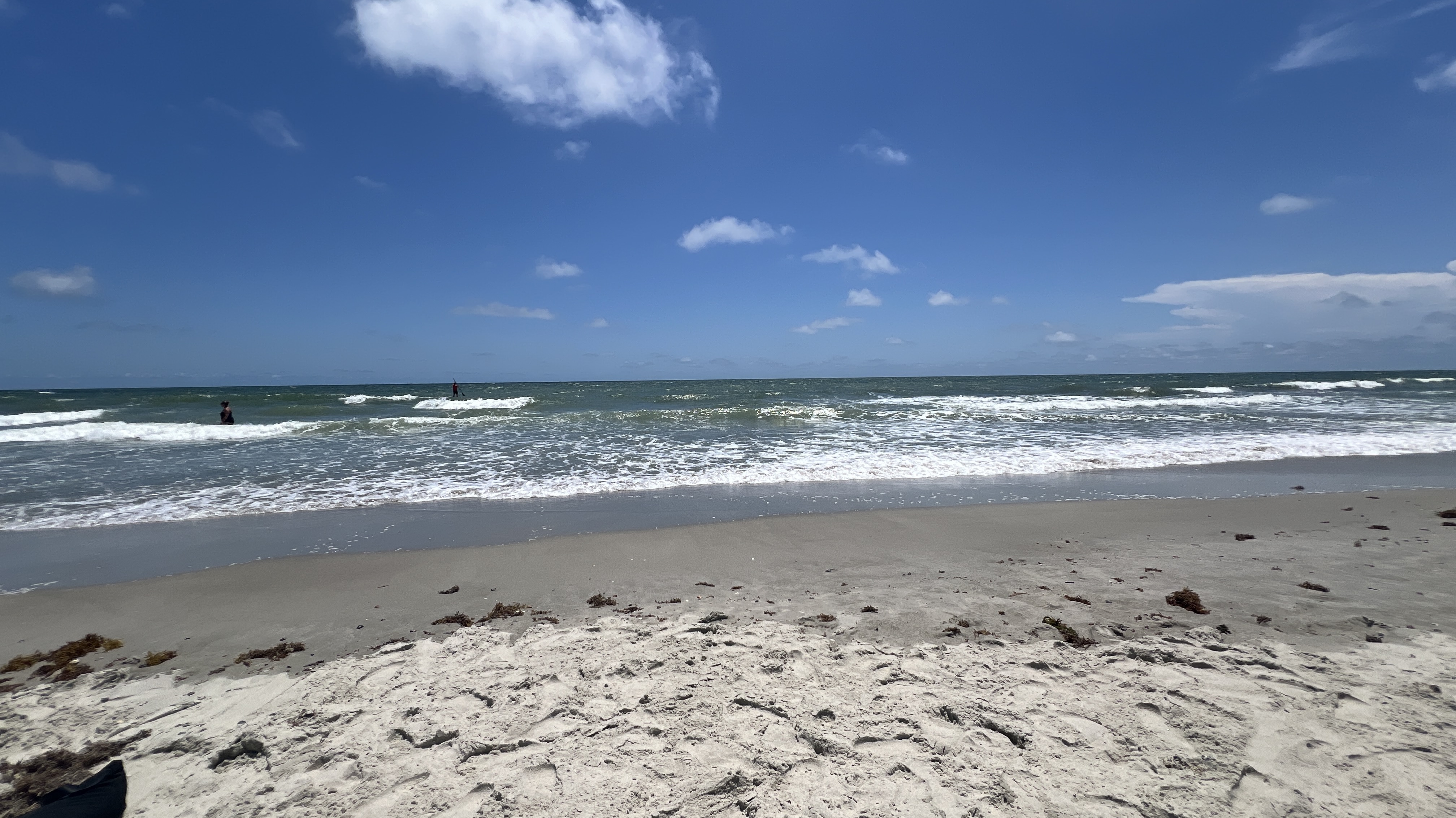 Swimmer in the surf on Oak Island beach on a sunny day
