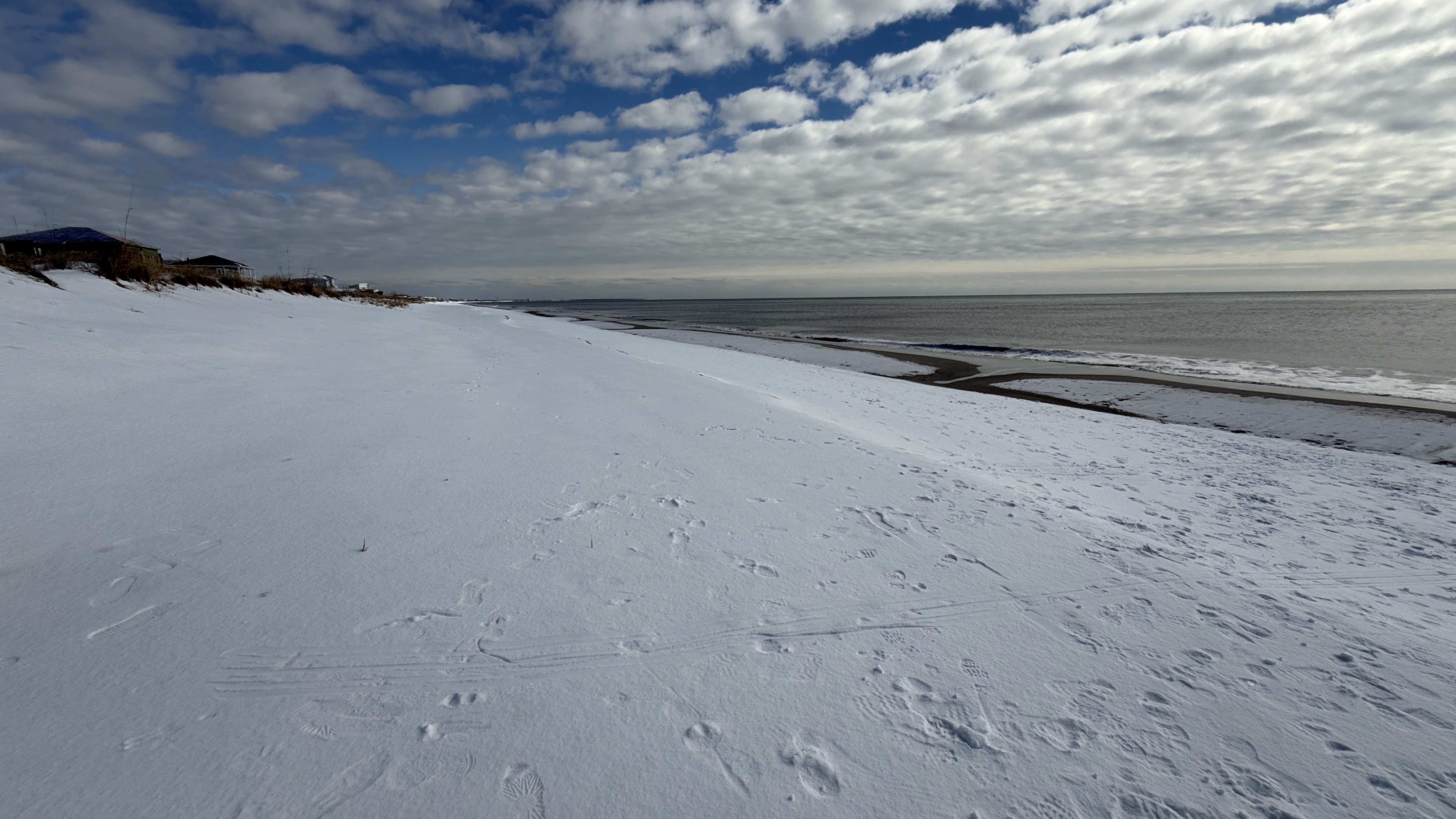 Snow-covered Oak Island beach dunes on a rare winter day