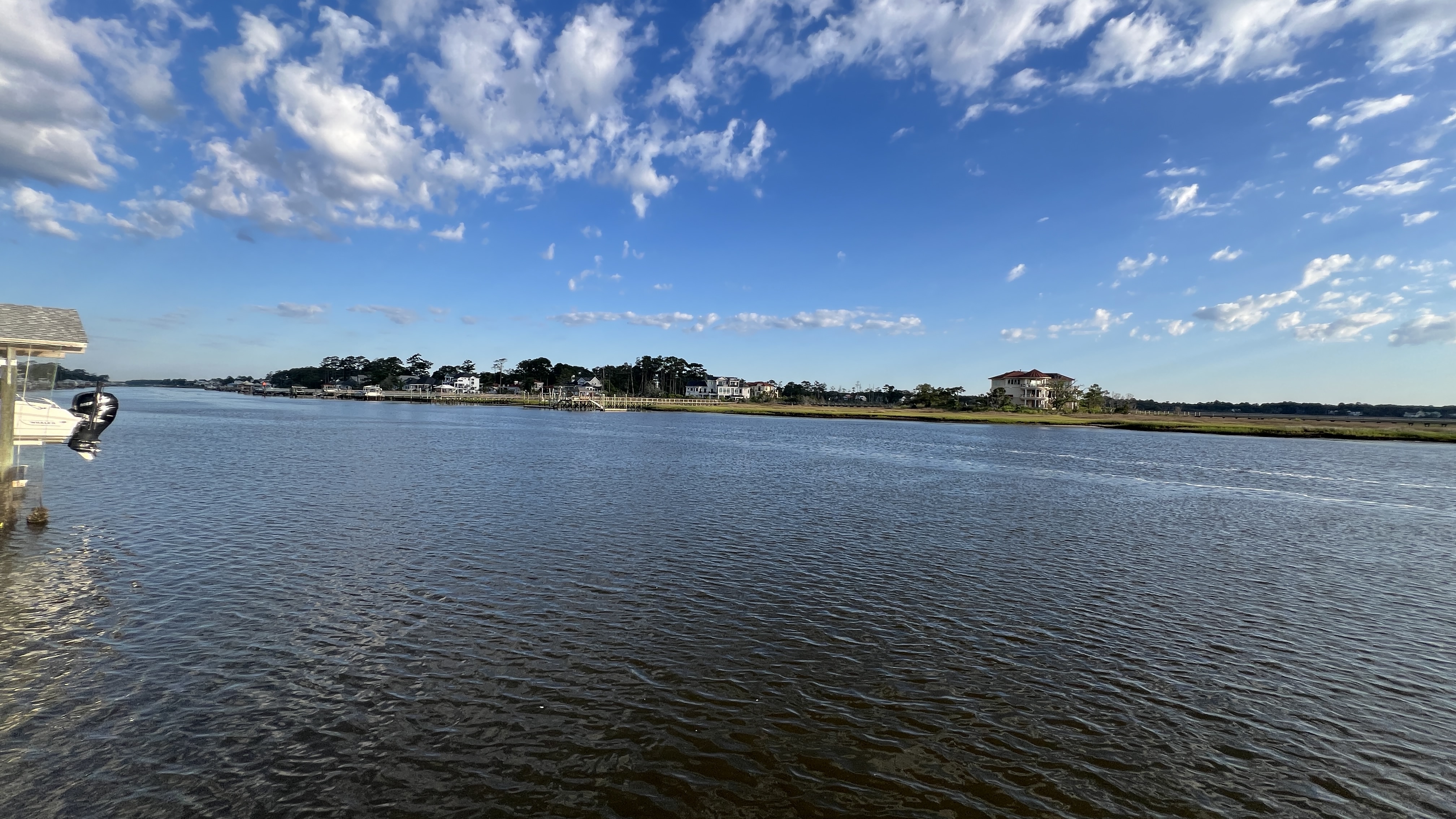 Oak Island Intracoastal Waterway at golden hour with boats docked along the marsh